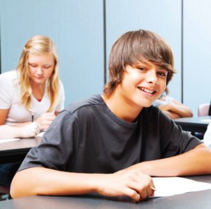 Smiling teenager at desk